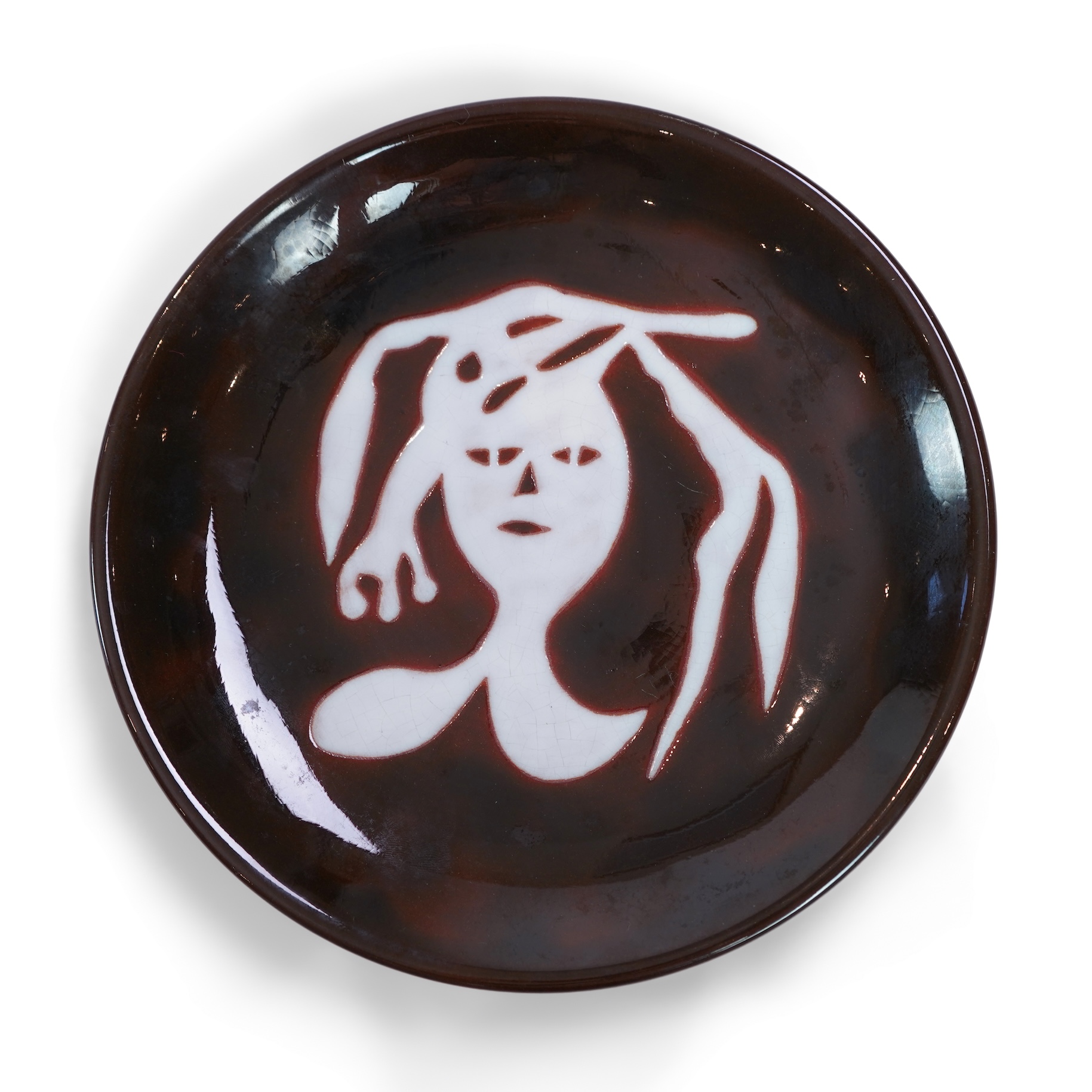 Jean Lurçat (1892-1966): A brown glazed earthenware plate, decorated with a stylised central figure